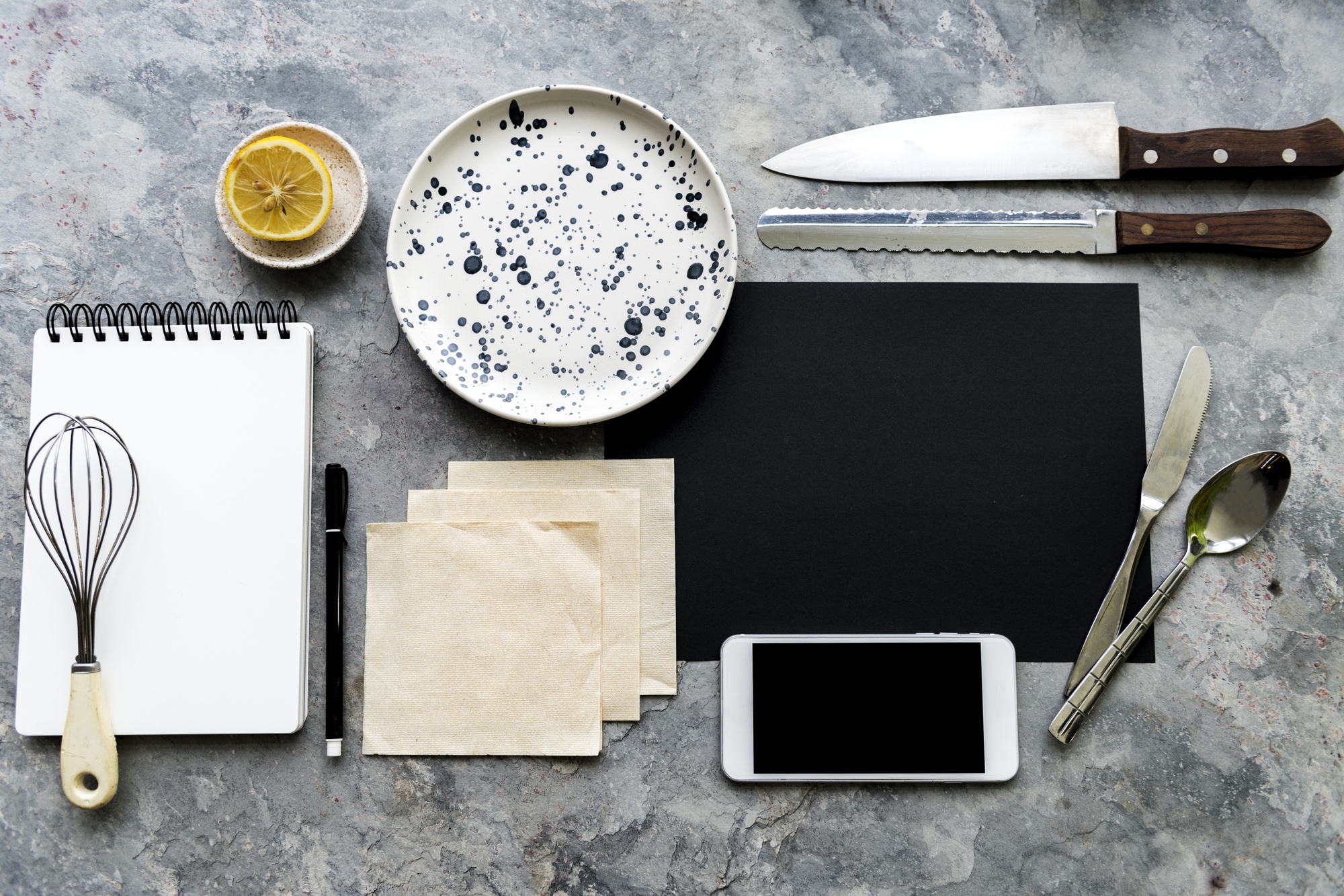 Small kitchen workspace with utensils and plated food